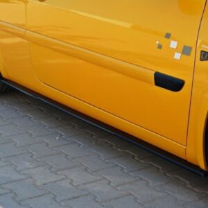 pol_po_Side-Skirts-Diffusers-suitable-for-Renault-Megane-RS-Mk2-276_3jpg - OPSHOLDERS Side view of a bright yellow sports car focusing on the lower door and black alloy wheel on a brick-paved surface.