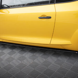Close-up of a bright yellow car door with a black handle, wheel visible at left and patterned floor below.