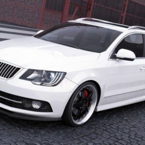 White station wagon with black aftermarket wheels and red brake calipers parked on a cobblestone street; Maxton Design badge on front grille.