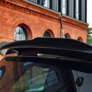 pol_po_Spoiler-Cap-suitable-for-Opel-ZAFIRA-B-OPC-487_5jpg - OPSHOLDERS Rear spoiler on a black hatchback, brick building with arched windows in the background.
