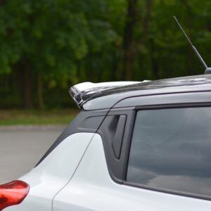 pol_po_Spoiler-Cap-suitable-for-Suzuki-SWIFT-6-SPORT-8255_3jpg - OPSHOLDERS Rear left corner of a silver SUV, showing the roofline and antenna against a blurred green background in a parking lot